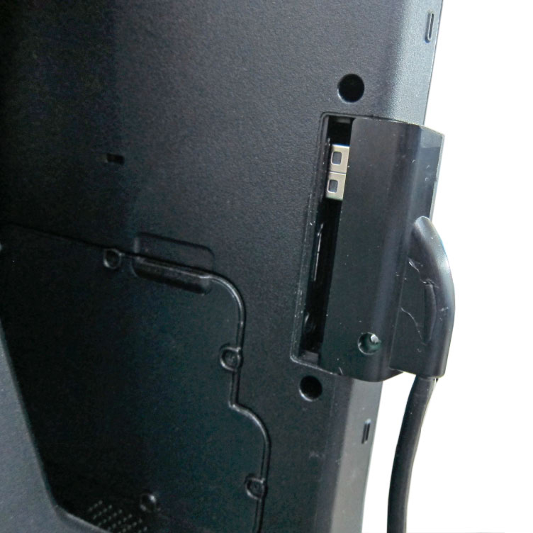 Rear view of the waterproof USB interface extension dongle for the Getac F110 tablet being installedin the F110 chassis